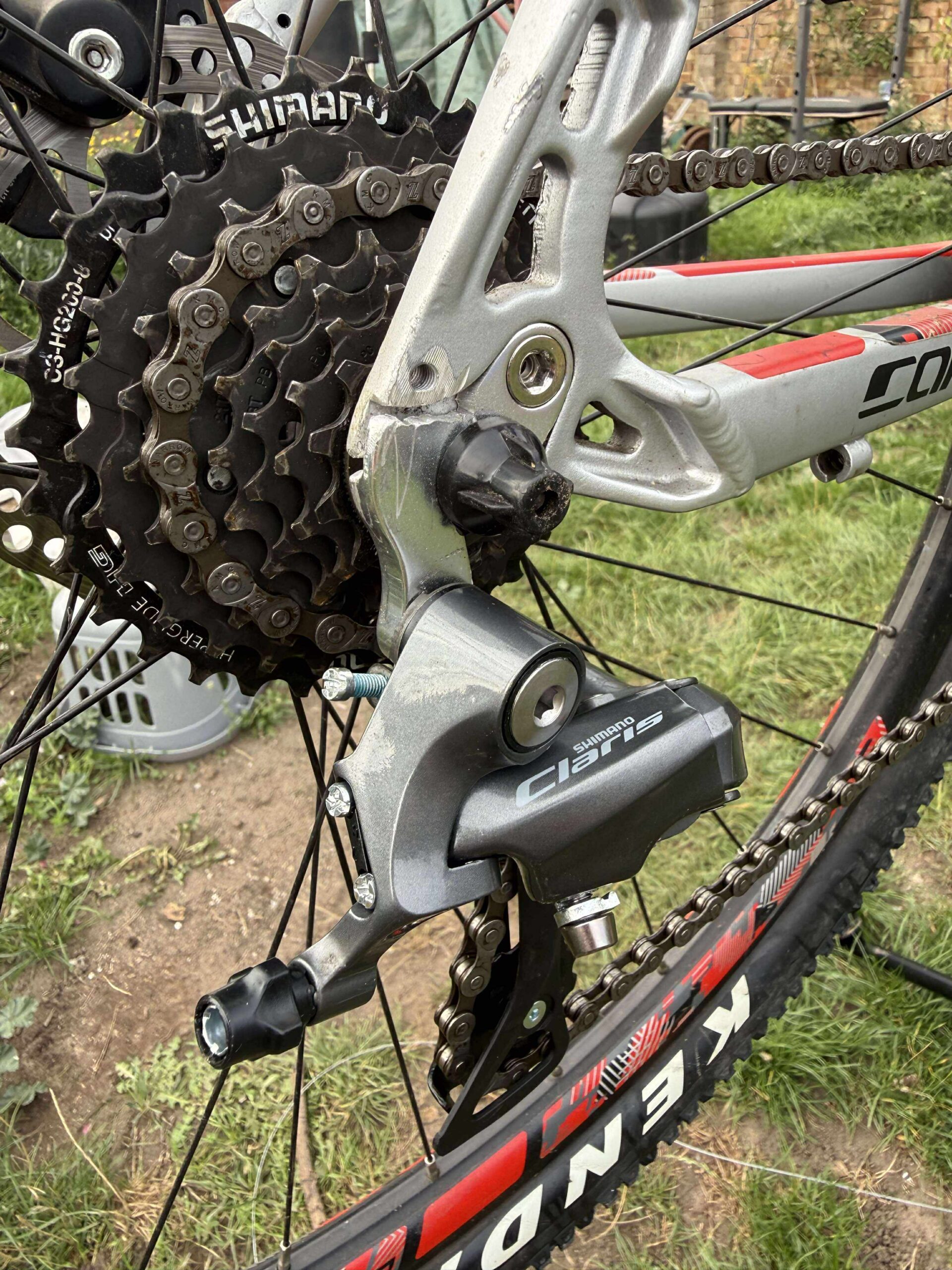 black road bike parked beside brown wooden wall