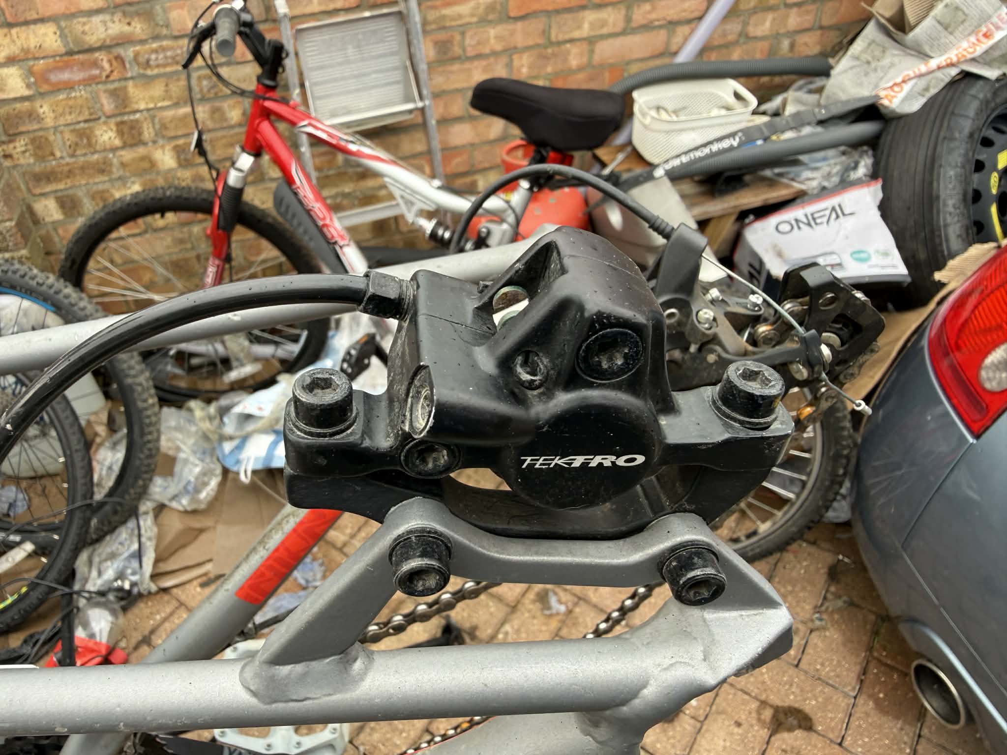 black road bike parked beside brown wooden wall